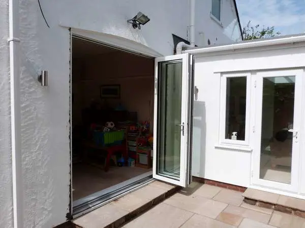 DAVENHAM , CHESHIRE : New Hybrid PvcU /Alumnium Bi Folding doors. Double glazed with 28mm